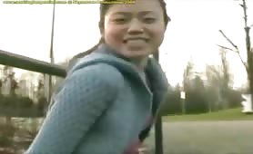 Cute Asian teen chick pees in her panties outdoor and gets all horny